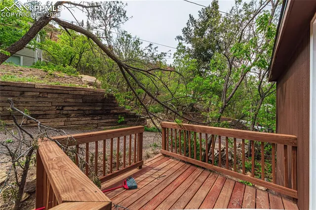 a view of balcony with wooden floor and fence