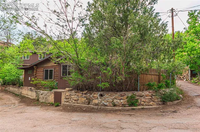 a view of backyard of house with outdoor seating and green space