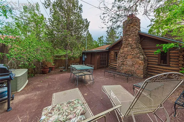a view of backyard with outdoor seating and trees