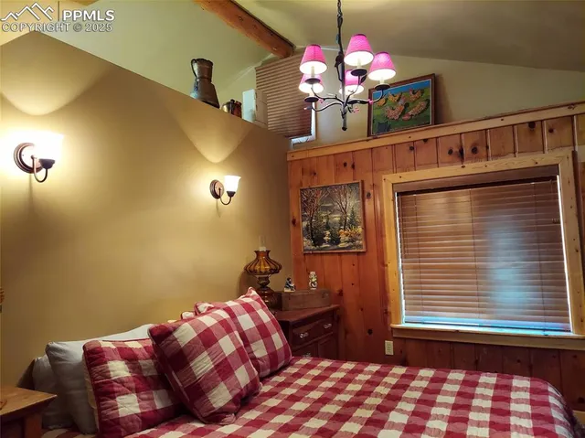 a bedroom with a bed and dresser with mirror