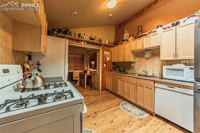 a kitchen with stainless steel appliances granite countertop a stove and a sink