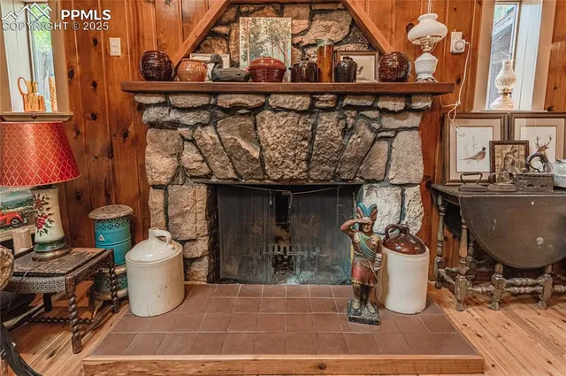a kitchen with a stove and a wooden floor