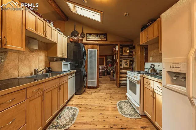 a kitchen with stainless steel appliances granite countertop a sink and cabinets
