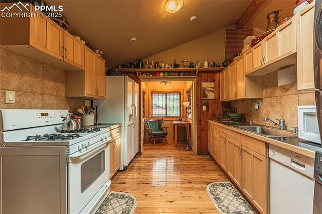 a kitchen with stainless steel appliances granite countertop a stove a sink dishwasher and a refrigerator