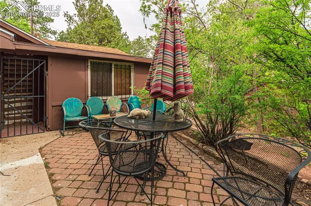 a backyard of a house with table and chairs