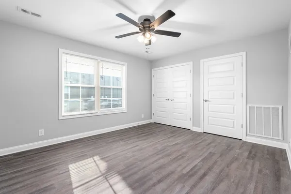 wooden floor in an empty room with a window