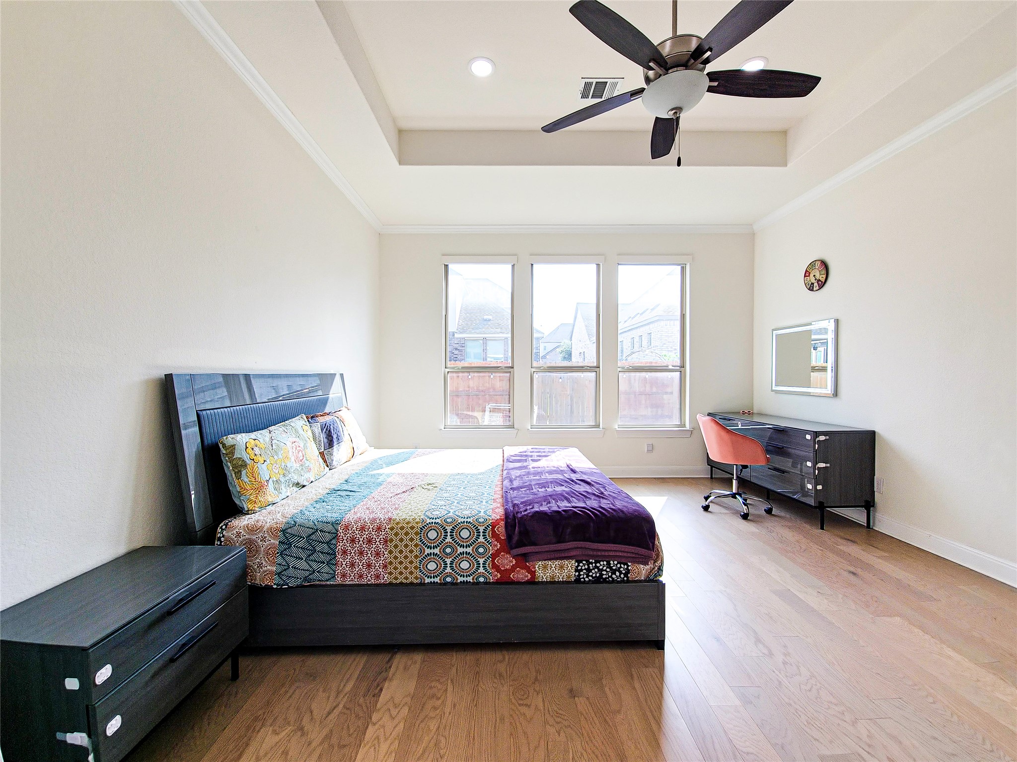 813 Sunny Ridge Drive Leander, TX 78641 - Photo 22 of 32 A tray ceiling and wood floors highlight this naturally illuminated sleeping area.