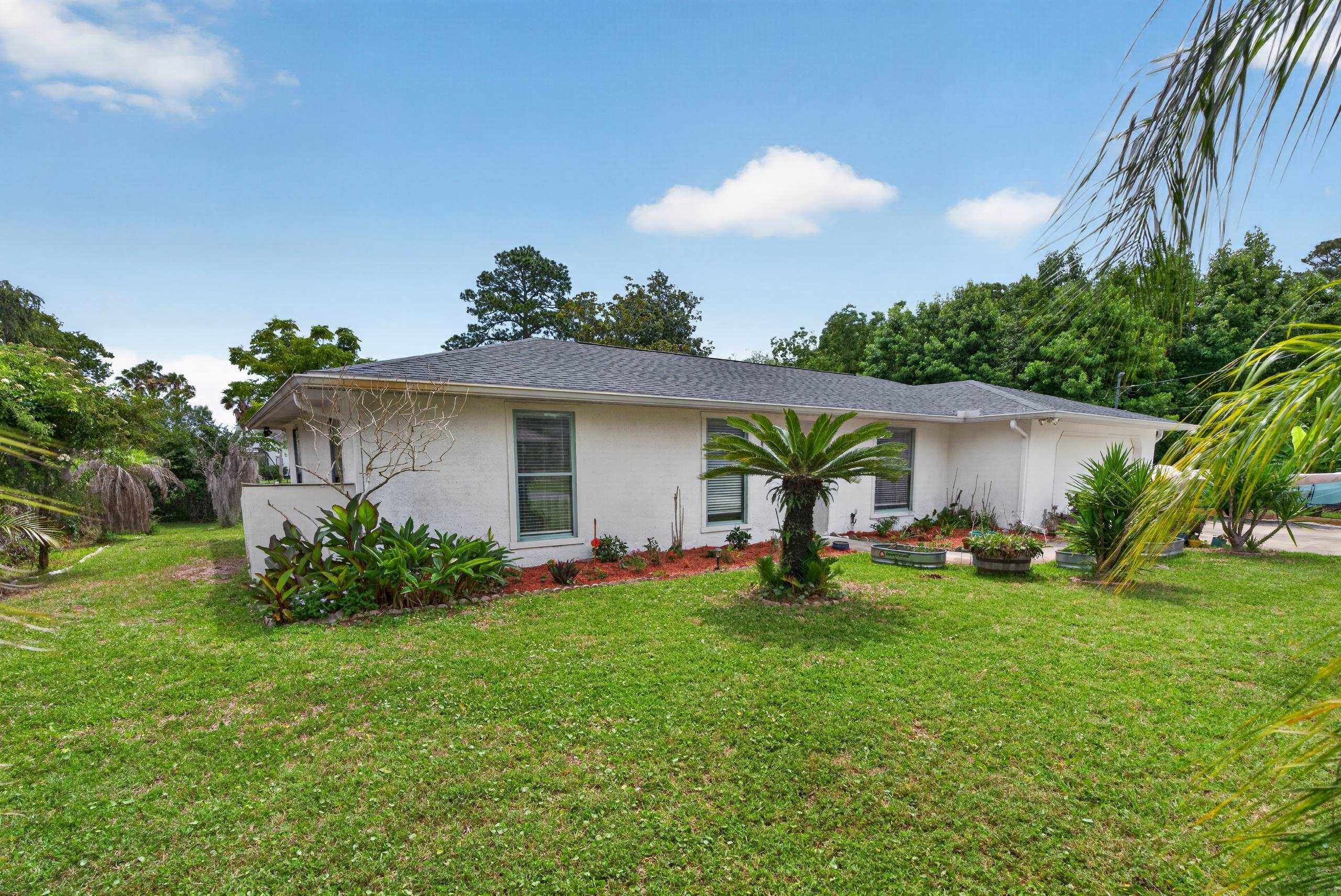 111 Pompano Road St. Augustine, FL 32086 - Photo 52 of 61 a view of a house with a yard and plants