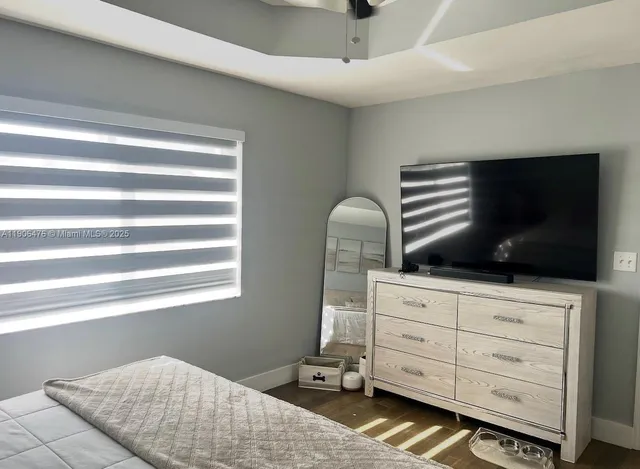 a bedroom with a bed and flat screen tv