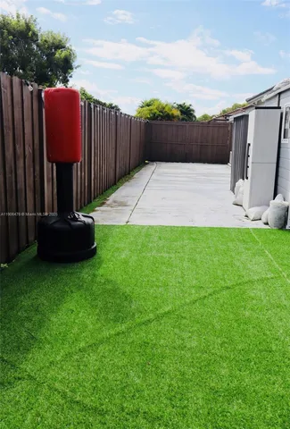 a view of a back yard with a pathway of a house