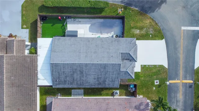 an aerial view of a house with a yard