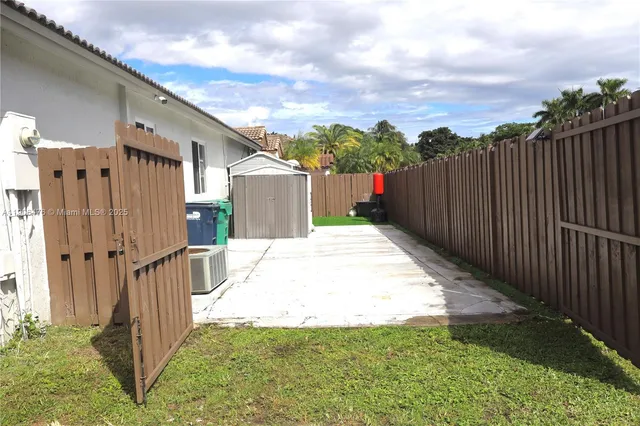 a view of a backyard with wooden fence