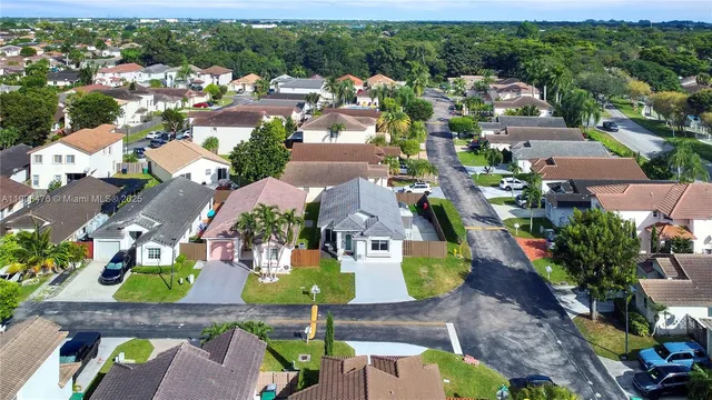 an aerial view of residential houses with outdoor space
