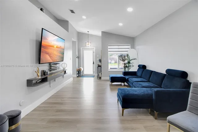 a living room with furniture and a flat screen tv