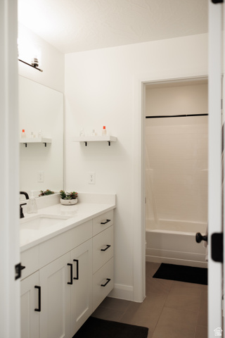 629 Spring Lily Drive St. George, UT 84790 - Photo 28 of 50 White vanity with black hardware, a rectangular undermount sink, and a light-toned countertop
