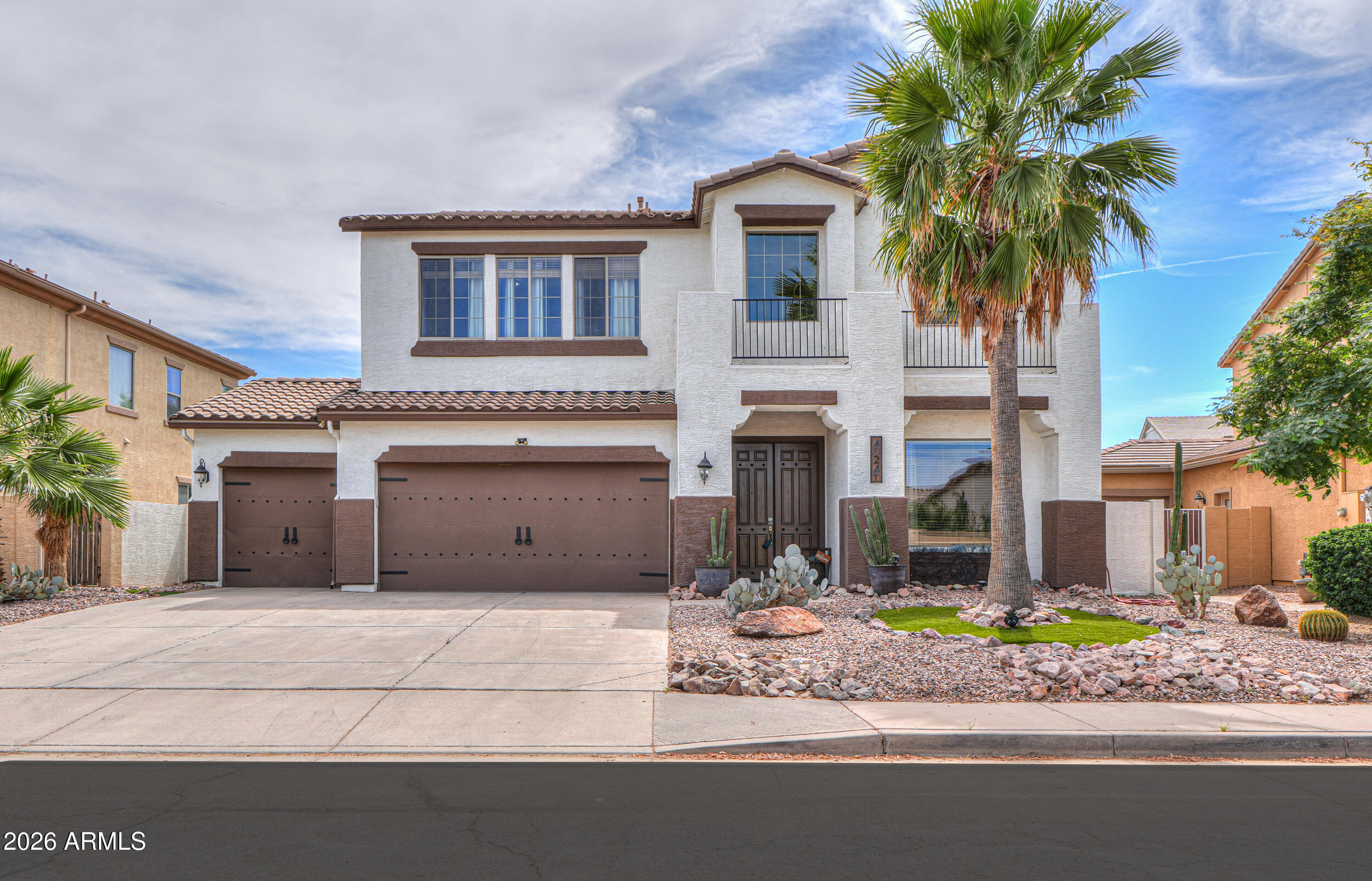 45247 West Jack Rabbit Trail Maricopa, AZ 85139 - Photo 1 of 75 a front view of a house with a garden and yard