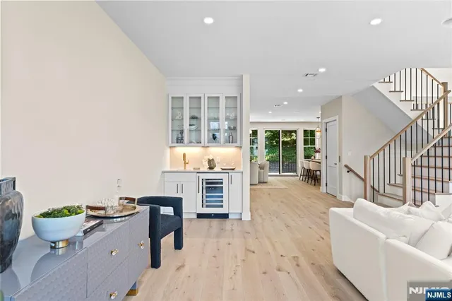 a view of kitchen with wooden floor and cabinets
