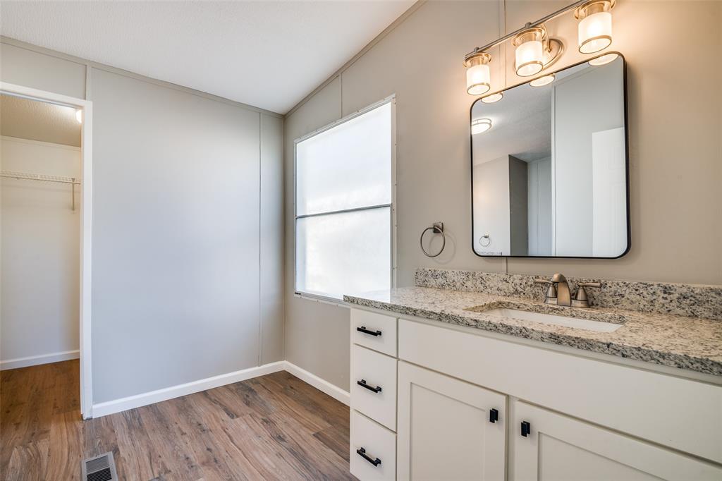 3176 North Ridge Crandall, TX 75114 - Photo 14 of 24 a bathroom with a double vanity sink and a mirror