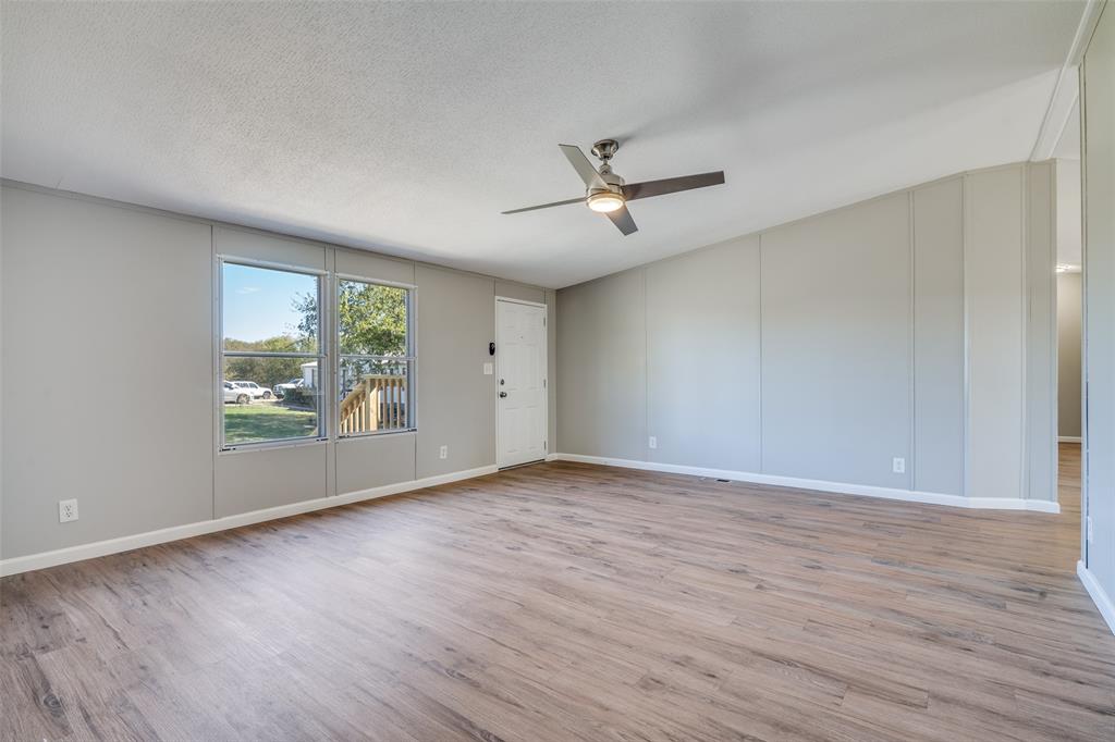 3176 North Ridge Crandall, TX 75114 - Photo 2 of 24 a view of empty room with wooden floor and fan