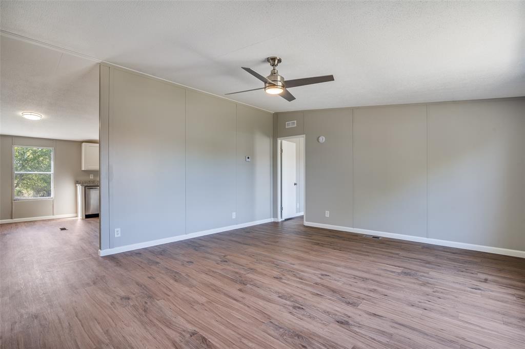 3176 North Ridge Crandall, TX 75114 - Photo 5 of 24 a view of an empty room with wooden floor and a window