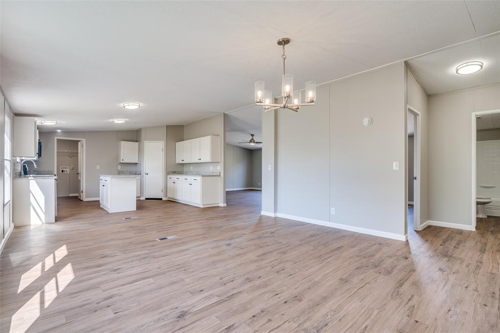 3176 North Ridge Crandall, TX 75114 - Photo 8 of 24 a view of a kitchen with a refrigerator wooden floor and a kitchen view