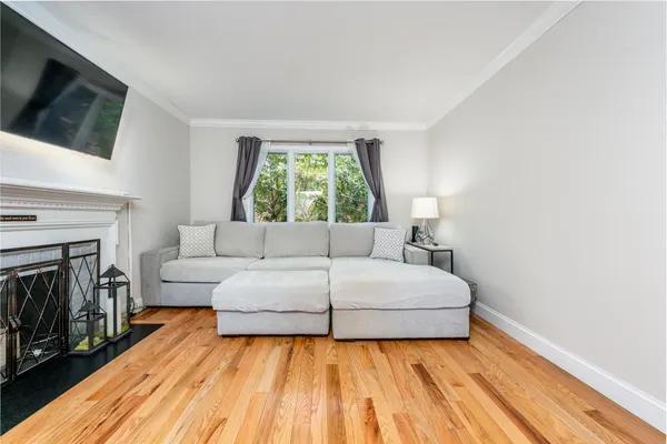 a living room with a bed and a flat screen tv