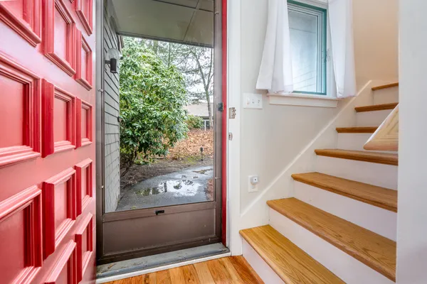 a spacious bedroom with a bed and a flat screen tv