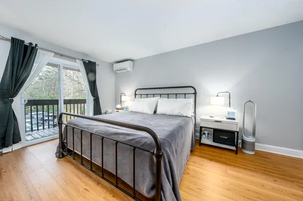 a bedroom with a bed and flat screen tv