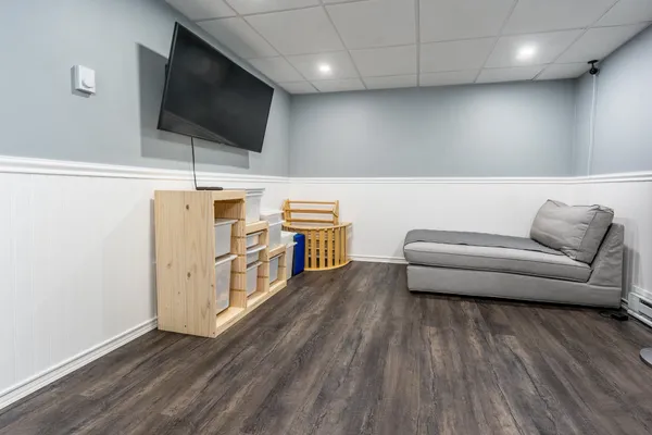 a view of a livingroom with furniture and a flat screen tv