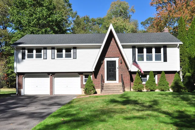 a front view of a house with a yard and garage
