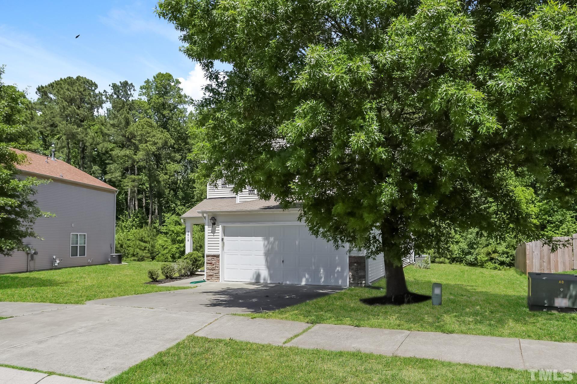 3618 Mountain Brook Circle Durham, NC 27704 - Photo 3 of 15 a front view of a house with a garden and tree