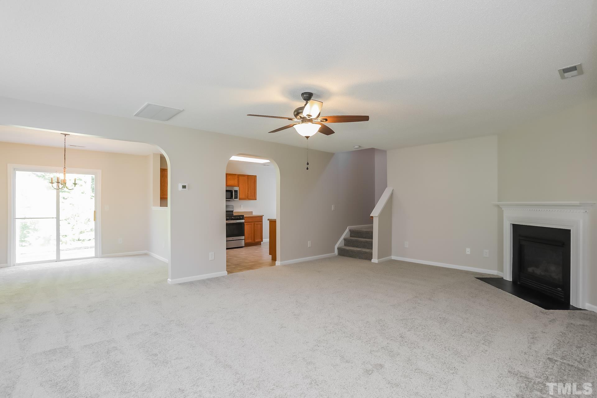3618 Mountain Brook Circle Durham, NC 27704 - Photo 4 of 15 an empty room with windows and fireplace