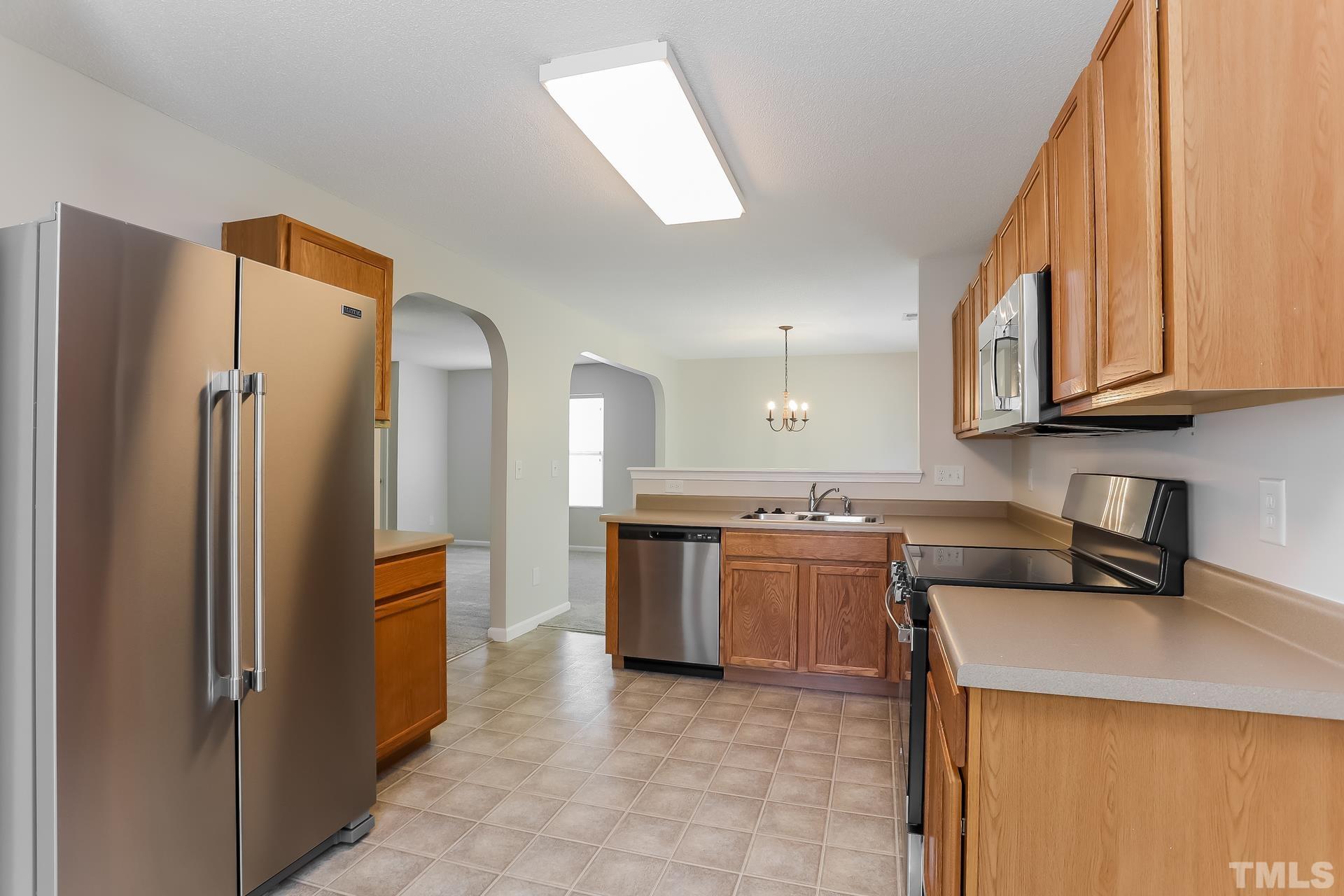 3618 Mountain Brook Circle Durham, NC 27704 - Photo 8 of 15 a kitchen with stainless steel appliances granite countertop a refrigerator a stove and a sink