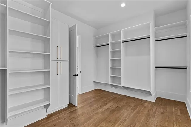 a view of walk in closet with empty racks