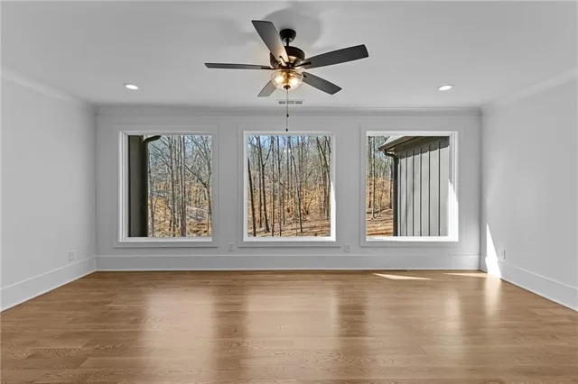 wooden floor in an empty room with a window