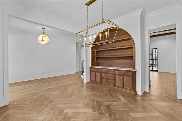 a view of an empty room with wooden floor fireplace and a window