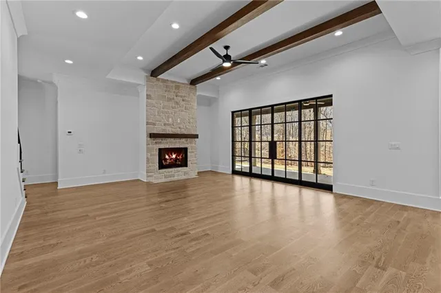 a kitchen with kitchen island granite countertop a stove a sink a center island and wooden floor