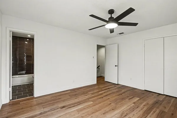 a view of empty room with wooden floor