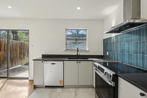 a kitchen that has a sink and a stove