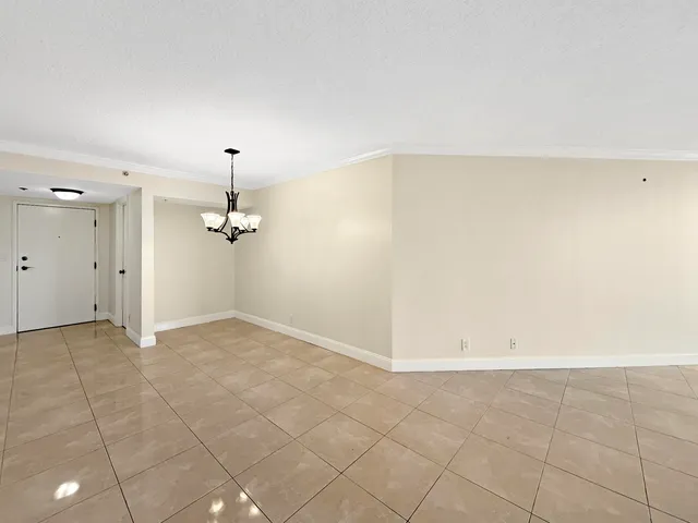 an empty room with a ceiling fan and bathroom
