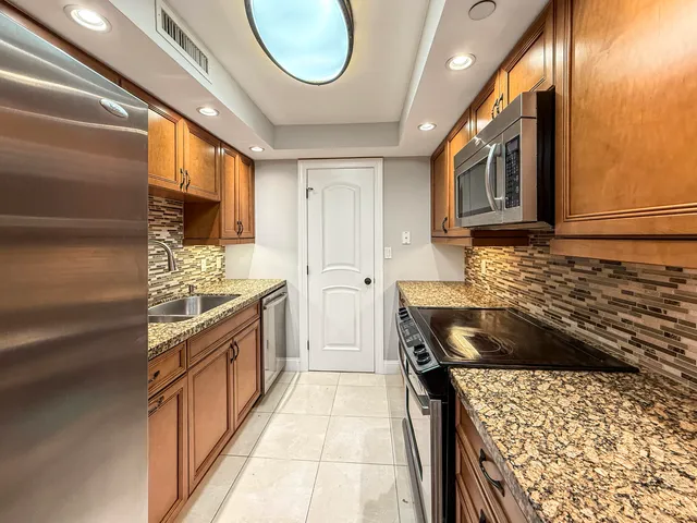 a kitchen with a stove a sink and a refrigerator