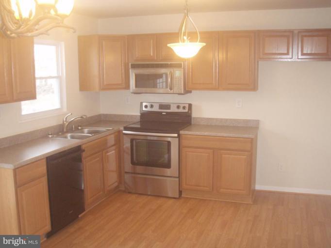 7108 Reno Road Windsor Mill, MD 21244 - Photo 2 of 29 a kitchen with a sink stove and cabinets