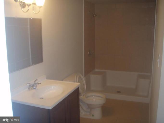7108 Reno Road Windsor Mill, MD 21244 - Photo 16 of 29 a bathroom with a sink toilet and shower
