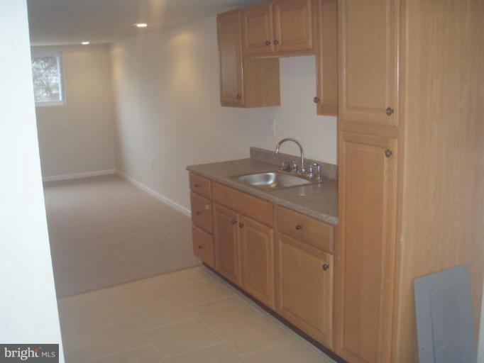 7108 Reno Road Windsor Mill, MD 21244 - Photo 19 of 29 a bathroom with a granite countertop sink a mirror and vanity
