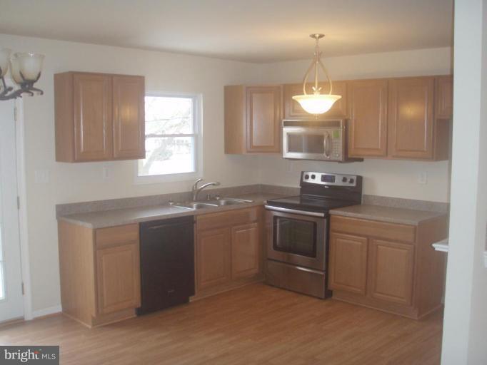 7108 Reno Road Windsor Mill, MD 21244 - Photo 3 of 29 a kitchen with a sink stove and microwave
