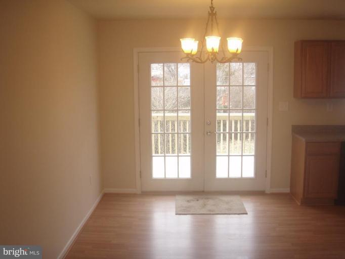 7108 Reno Road Windsor Mill, MD 21244 - Photo 5 of 29 a view of an empty room with wooden floor and a window