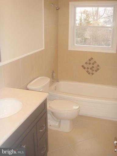 7108 Reno Road Windsor Mill, MD 21244 - Photo 7 of 29 a bathroom with a toilet a sink and a bathtub
