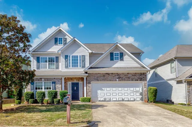 a front view of a house with a yard
