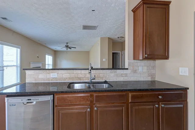 a sink with granite countertop a sink and cabinets