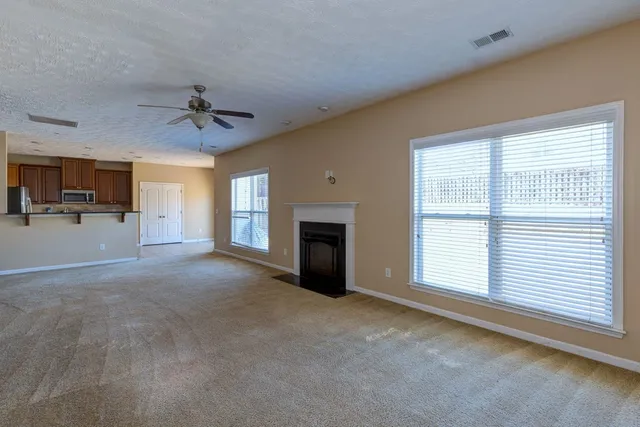 a view of a livingroom with an empty space and a fireplace